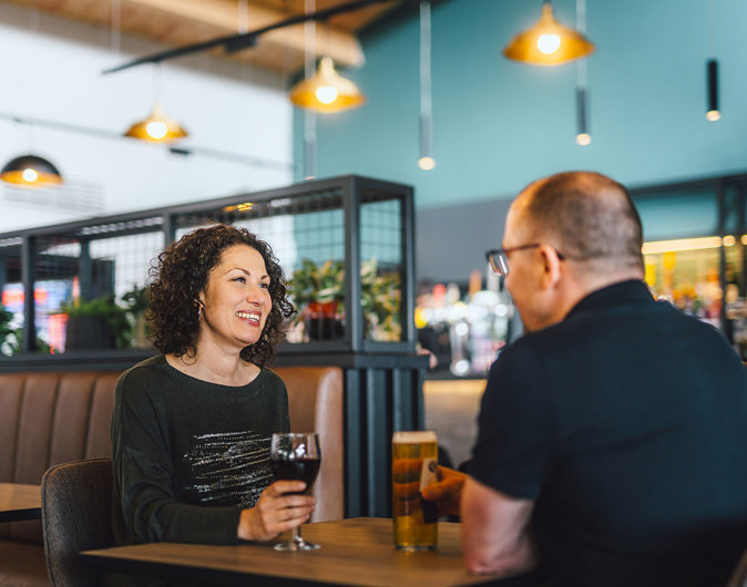 Couple enjoying drinks in The Drift Inn bar and restaurant 
