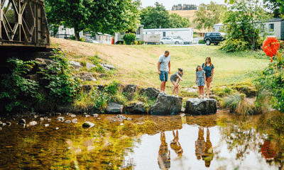 Family exploring by the river at Riverside Leisure Park