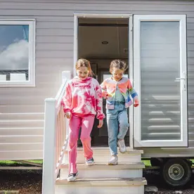 Children running out of a caravan