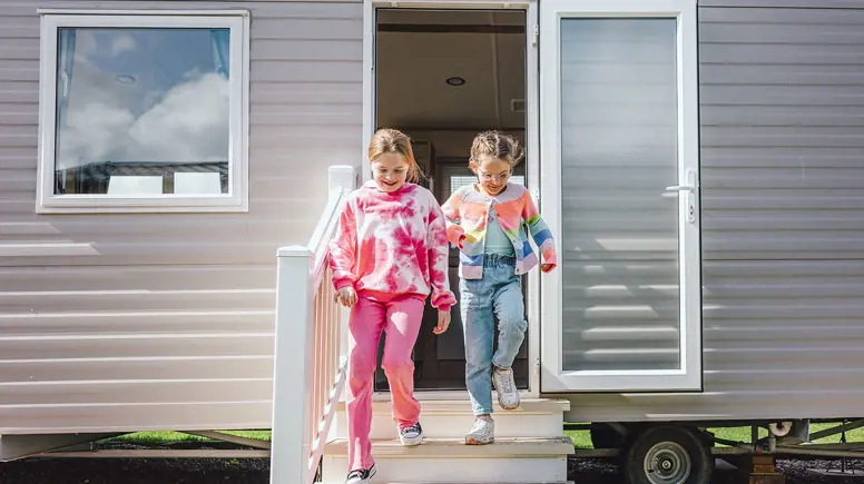 Children running out of a caravan