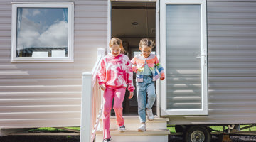 Children running out of a caravan