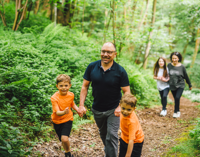 Family walking in forest at Coldingham Bay Leisure Park