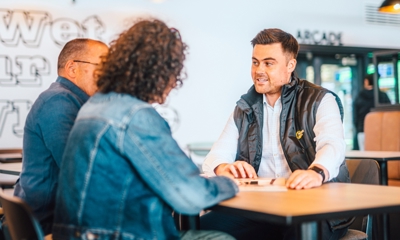 Couple chatting to salesman