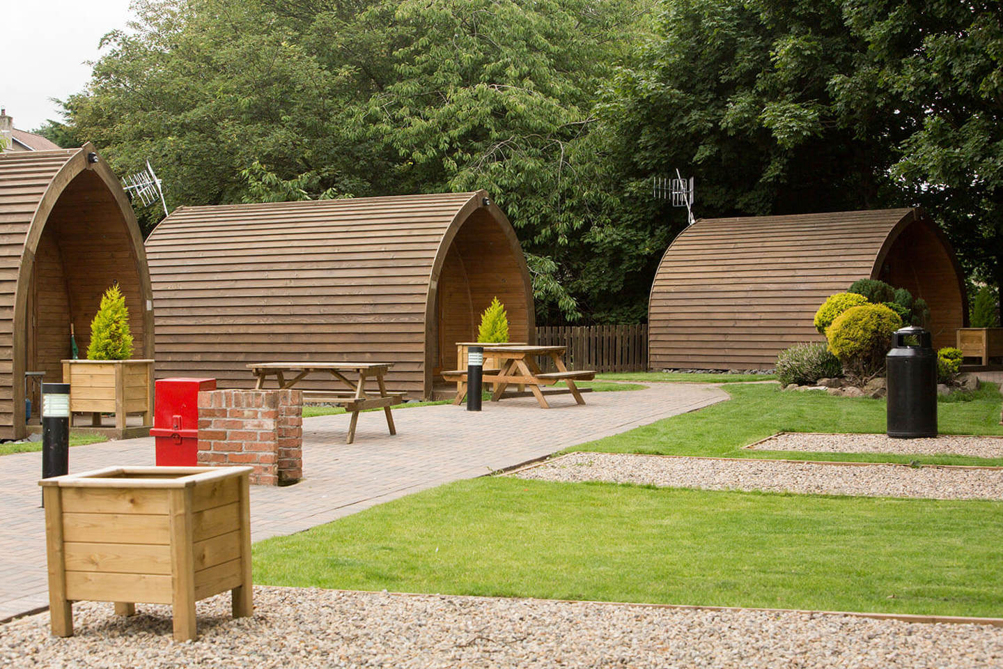 Camping pod accommodation with patios and picnic tables 