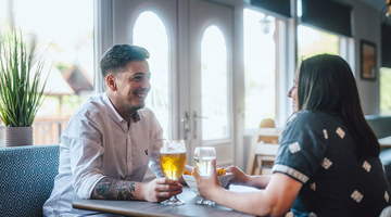 Couple enjoying a drink at Scoutscroft Leisure Park