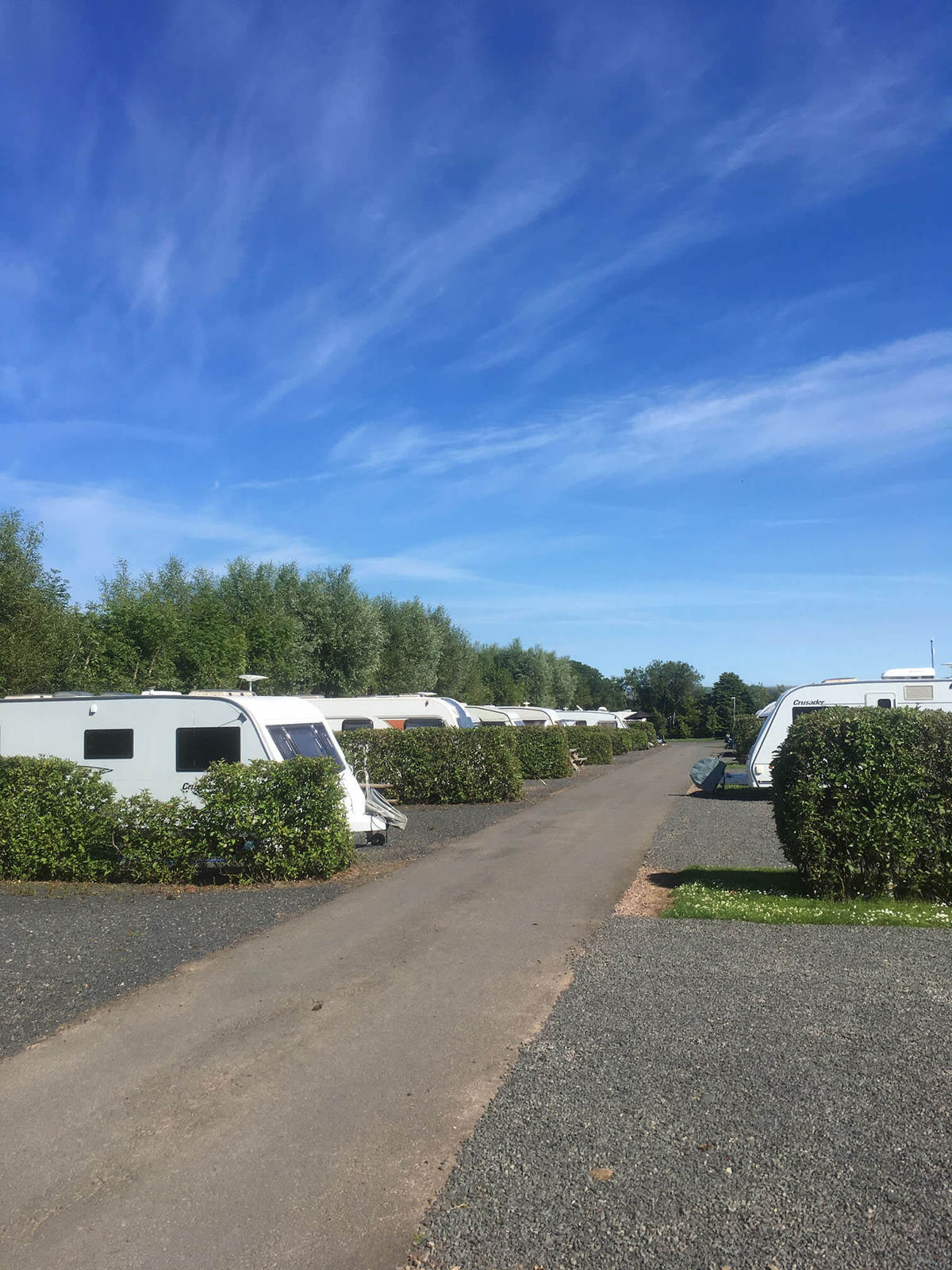 Touring vans and motorhomes at a UK holiday park 