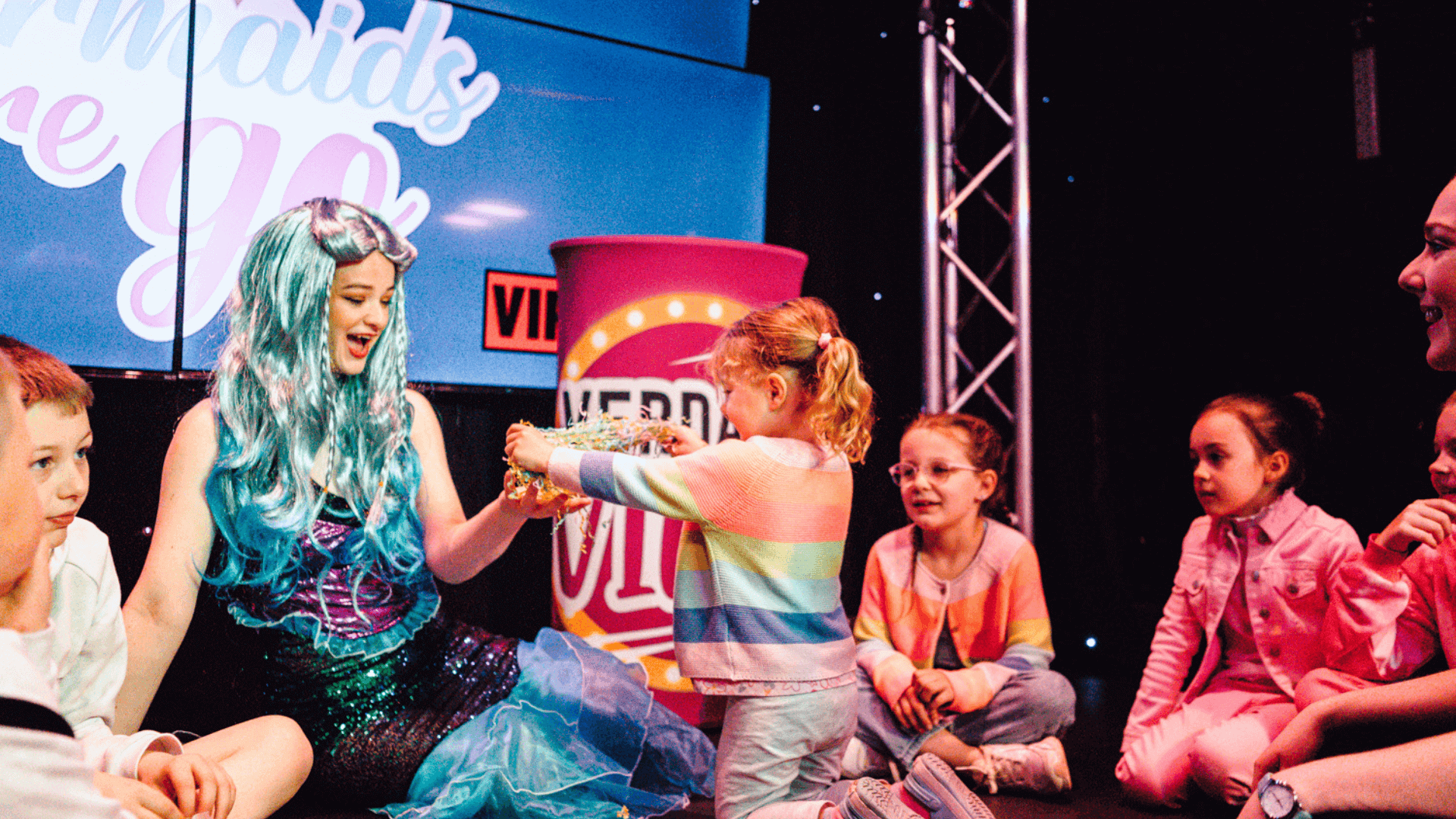 Lady dressed as mermaid with children