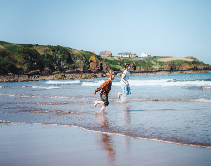 Children in the sea at Coldingham Beach near Scoutscroft 