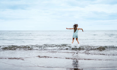 Child jumping in the sea