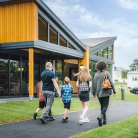 A family walking towards The Drift Inn bar and restaurant 
