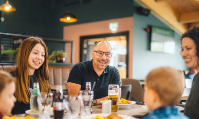 A family enjoying food and drinks indoors at The Drift Inn bar and restaurant 